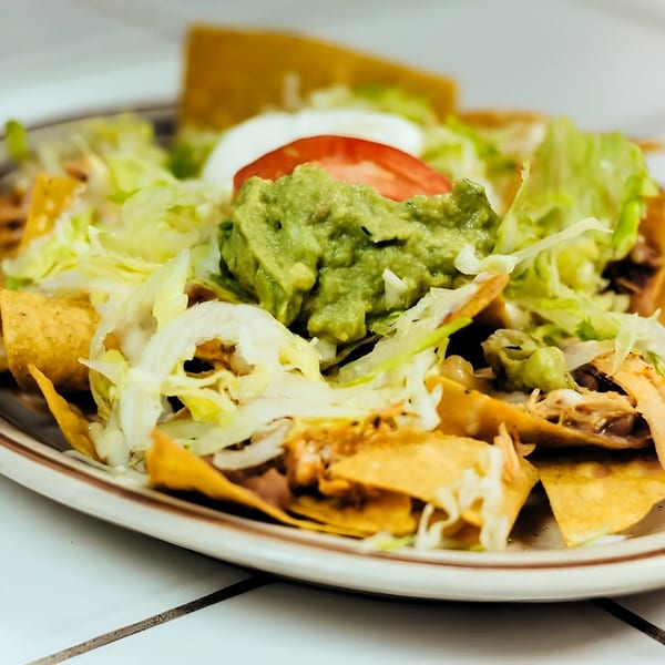 La Unica Mexican Restaurant's nachos with guacamole, sour cream, tomato, and shredded lettuce.