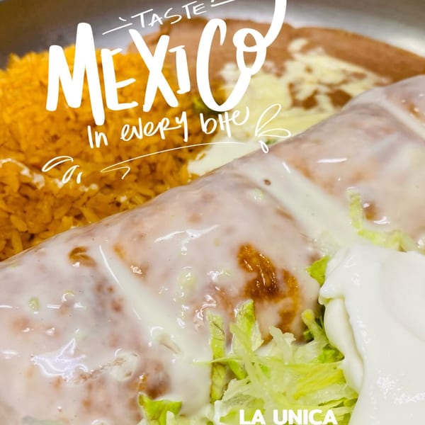 A La Unica Mexican Restaurant burrito covered in white sauce, with rice and beans.