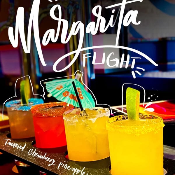 A flight of four colorful margaritas, including tamarind, strawberry, and pineapple flavors, at La Unica.