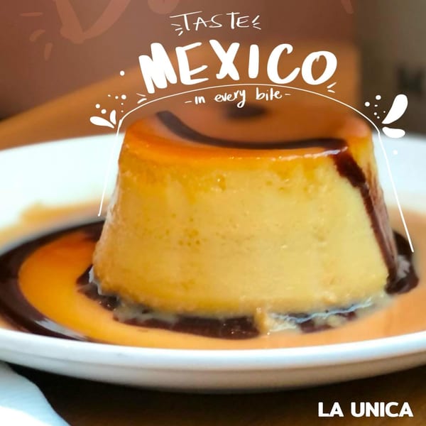 A golden flan dessert with dark caramel sauce on a white plate, from La Unica Mexican Restaurant.