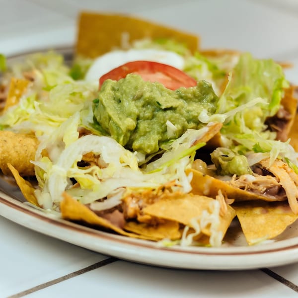 La Unica Mexican Restaurant's nachos with guacamole, sour cream, tomato, and shredded lettuce.