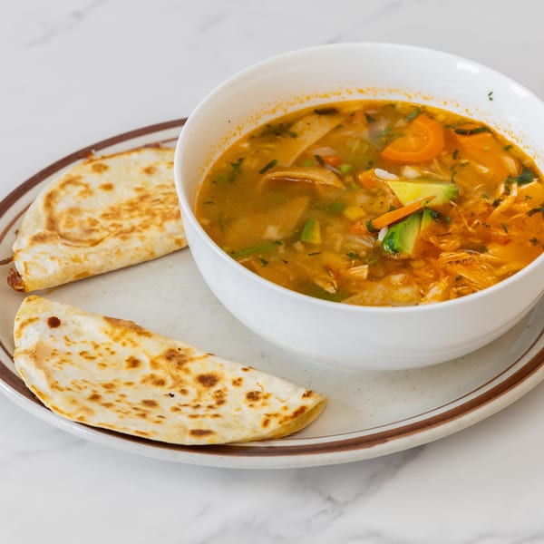 La Unica Mexican Restaurant's chicken soup with vegetables and avocado, served with two quesadillas.